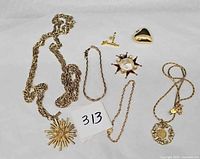 Group view of all seven gold-tone jewellery items