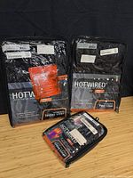 Three Hotwired heated apparel packages: jacket liner, pant liner, glove liners