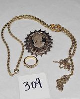 Brooch, ring and necklace laid out together