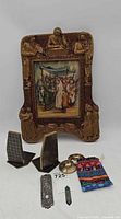 Entire lot showing framed Artini art, pair bookends, Mezuzah cases, brass bells, pouch