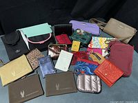Full grouping of umbrella, wallets, pouches and purse laid out