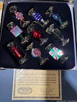 Full set of nine glass candy ornaments in box with certificate visible