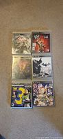 Front view of all six PS3 games in cases
