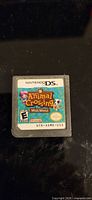 Front view of Nintendo DS Animal Crossing: Wild World cartridge showing label and ESRB rating