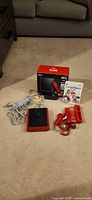 Overview of Wii Mini console, box, cables, controllers, Mario Kart game