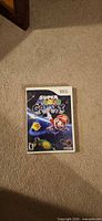 Front of Super Mario Galaxy Wii case on carpet