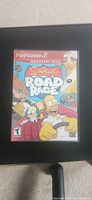 Front cover of The Simpsons Road Rage Greatest Hits PS2 game case