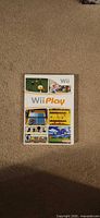 Front of Wii Play case showing title and mini-game images