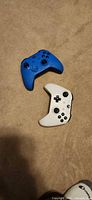 Front view showing blue and white Xbox controllers