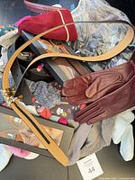 Overview showing belts, leather gloves, socks pile