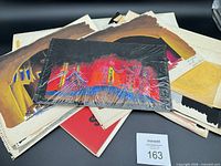 Stack of assorted painted and drawn set designs