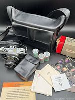 Full lot: camera with lens, flash box and case, film, manuals, bag