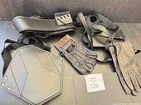 Full lot overview showing back sheath harness, pouch, both pairs of gloves, nylon strap