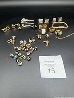 Full layout of assorted costume jewelry pieces on black background