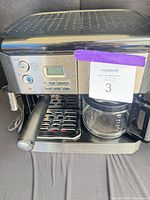 Full view of DeLonghi espresso and coffee machine with carafe inserted