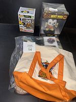 Group shot of both Funko figures, tote bag and sealed blanket