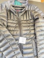Front view of black and partial navy Tommy Hilfiger quilted jackets