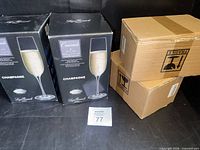 Two Luigi Bormioli Crescendo champagne glass boxes and two plain shipping boxes