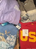 Assorted graphic T-shirts laid out showing designs and colors