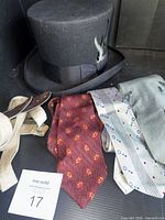 Group shot showing top hat, three ties, suspenders