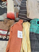 Stack of multiple sweaters showing colors and patterns