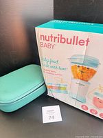 Nutribullet Baby boxed set beside teal Willow storage case