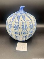 Front view of blue and white pumpkin-shaped porcelain ginger jar with lid