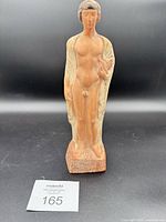 Full front view of terracotta statue on base