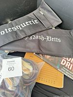 Two director chair backs, bag of coiled cords, police notes board, partial scene photo