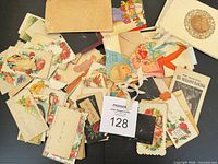 Pile of assorted Victorian calling cards, greeting cards, envelope visible