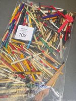 Full bag of assorted advertising pens and pencils with MaxSold lot card