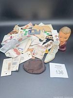 Pile of vintage button cards, loose buttons, boot figurine, bust, coin purse visible