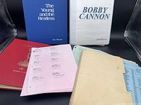 Front view of three binders, loose script pages and paperwork