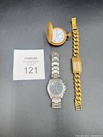 Group shot of all three watches: Rolex chain bracelet watch, pocket watch, Structure wristwatch