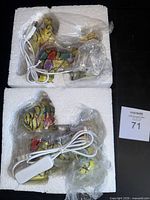 Two dog-shaped stained glass lamps in Styrofoam with USB cables