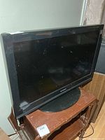 Front view of Dynex 26-inch TV on stand
