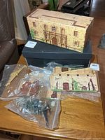 Tin lithographed Alamo box, facade panels, bags of figures on table