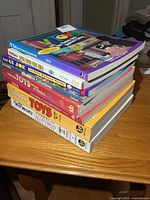 Stack of eight toy collecting reference books showing spines