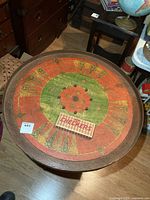 Full view of painted crokinole surface with checkers box on top