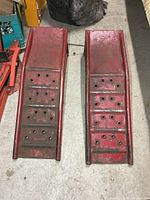 Top view of both red steel ramps showing perforated treads and wear
