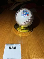 Baseball in display case showing Blue Jays logo