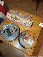 Overall lot showing tin, cast iron pieces and coronation carriage box