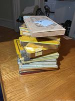 Stack of assorted cigarette tins with wooden box on top