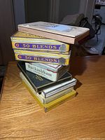 Stack of assorted cigarette tins and wooden box