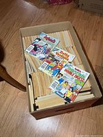 Full cardboard box filled with digest-size comics; three Archie digest issues displayed on top