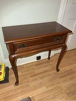 Front view of solid cherry hall table, drawer visible