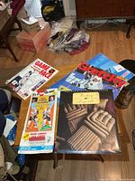 Group shot of three sealed calendars, Hockey Tips pack, colouring book