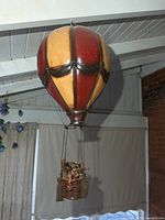 Full view of hanging ceramic hot air balloon with basket