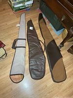 All three soft rifle cases laid out on floor