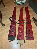 Three red soft rifle cases laid flat showing overall design